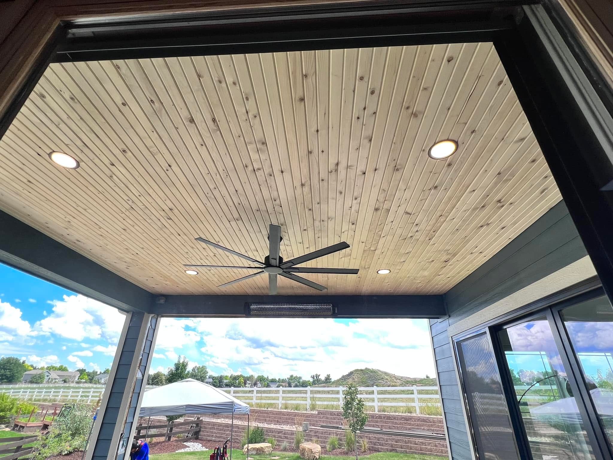 Ceiling fan and recessed lighting installed on a back patio during a living room, dining room, and outdoor kitchen remodel in Louisville, CO