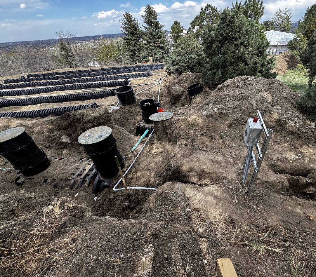 Open trench showing septic system electrical conduit and rough-in wiring installed by Bornschein Electric